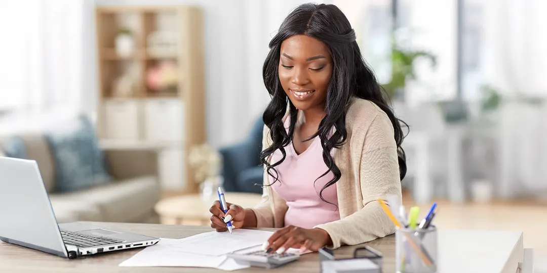 A woman working through her finances at home