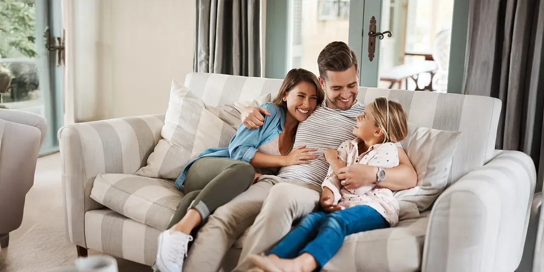 A family relaxing together on the sofa