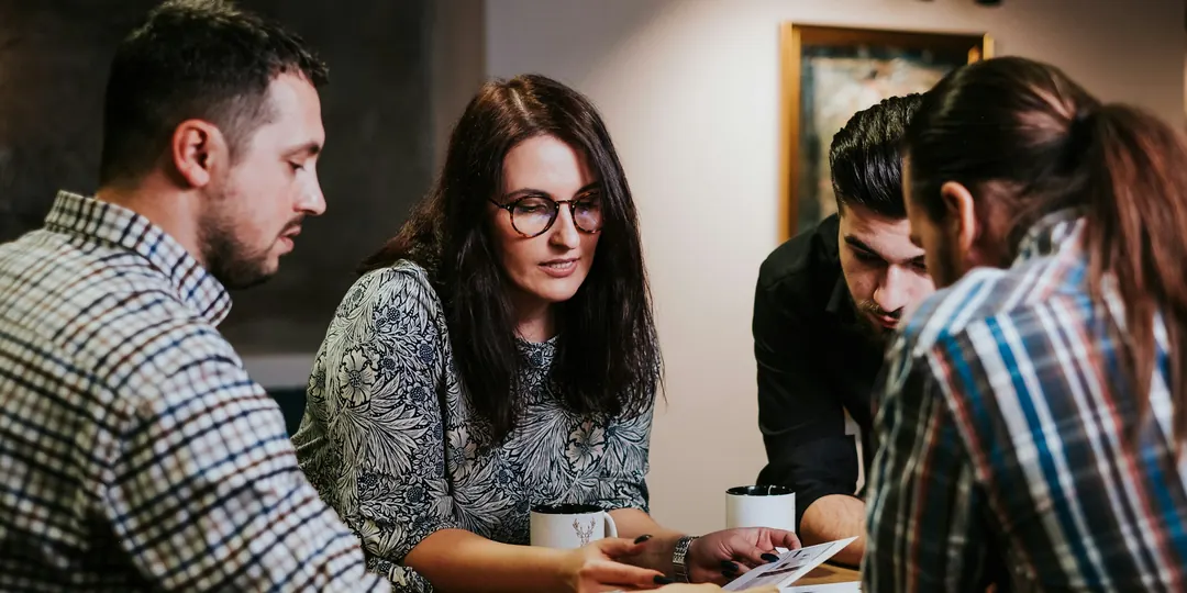 Business owners going through paperwork together around a table
